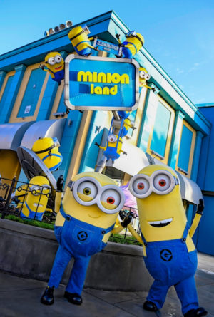 Two Minions in front of the Minion Land Sign