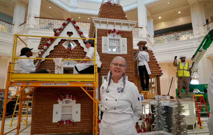 Pastry Chef Kristine Farmer in Front of Disney's Grand Floridian Gingerbread House 2023